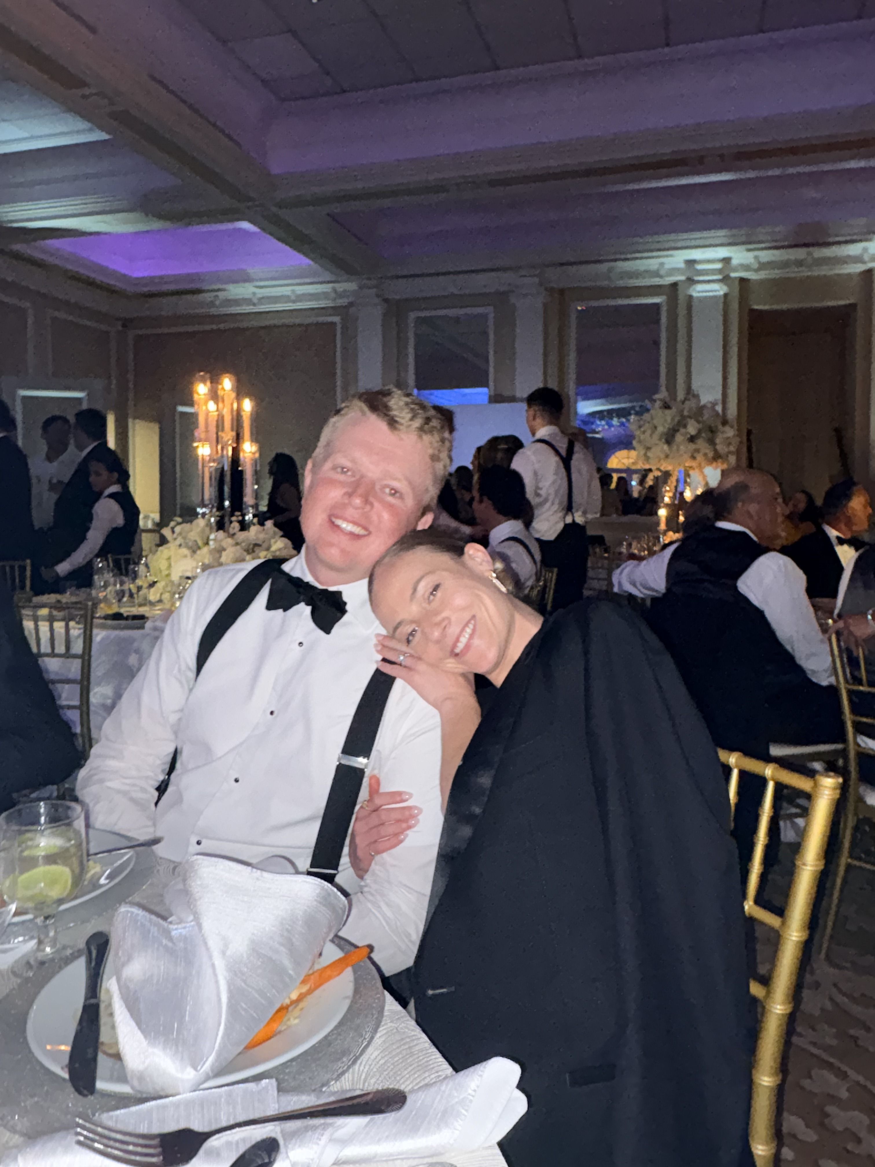 Friends seated at a reception table, ballroom