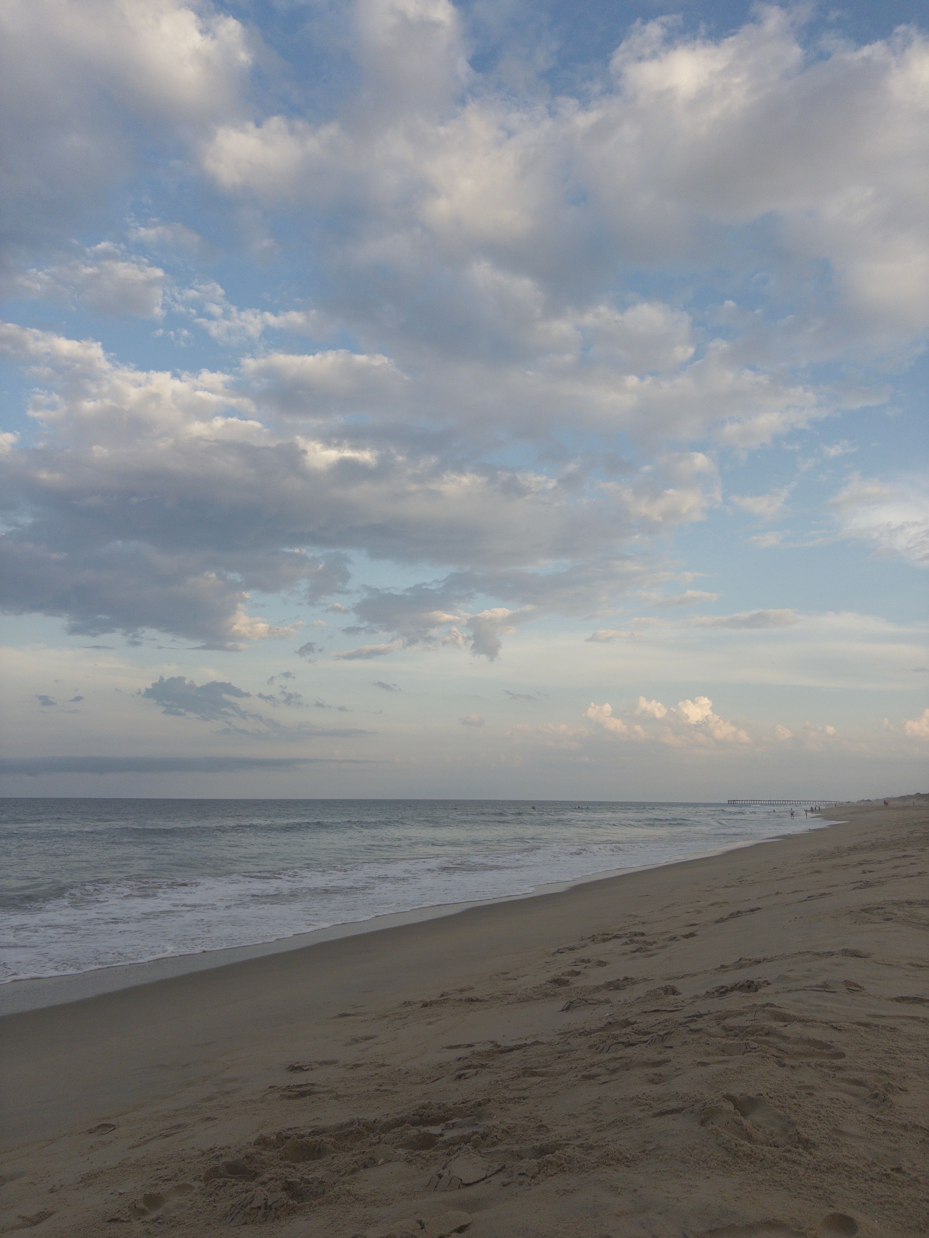 Shoreline stretching toward a pier